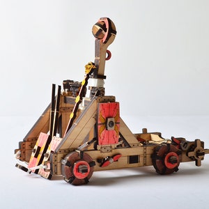 Side view of the wooden catapult, highlighting the detailed design achieved through CNC laser cutting.