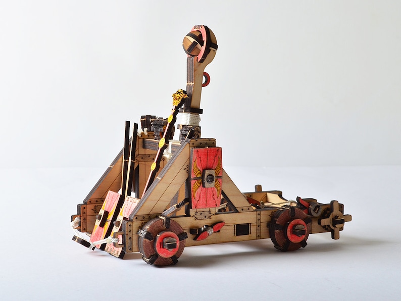 Side view of the wooden catapult, highlighting the detailed design achieved through CNC laser cutting.