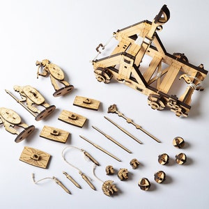Exploded view of the catapult's components, illustrating the DIY assembly process from the laser-cut template.