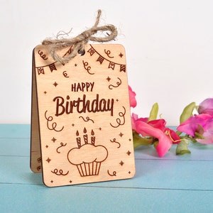 Finished engraved wood card with a cupcake design and twine bow. Tested on laser cutting machines with 3mm wood.