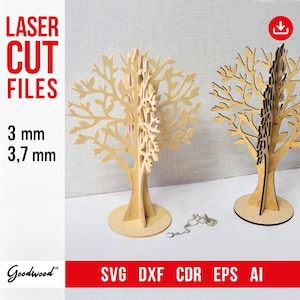 May include: Two laser cut wooden tree designs, one in natural wood and one in dark wood, with a chain hanging below the natural wood tree. The text "LASER CUT FILES" is in red at the top left of the image. The text "3 mm 3,7 mm" is in black at the bottom left of the image. The text "SVG DXF CDR EPS AI" is in red at the bottom right of the image. The text "Goodwood" is in black at the bottom left of the image.