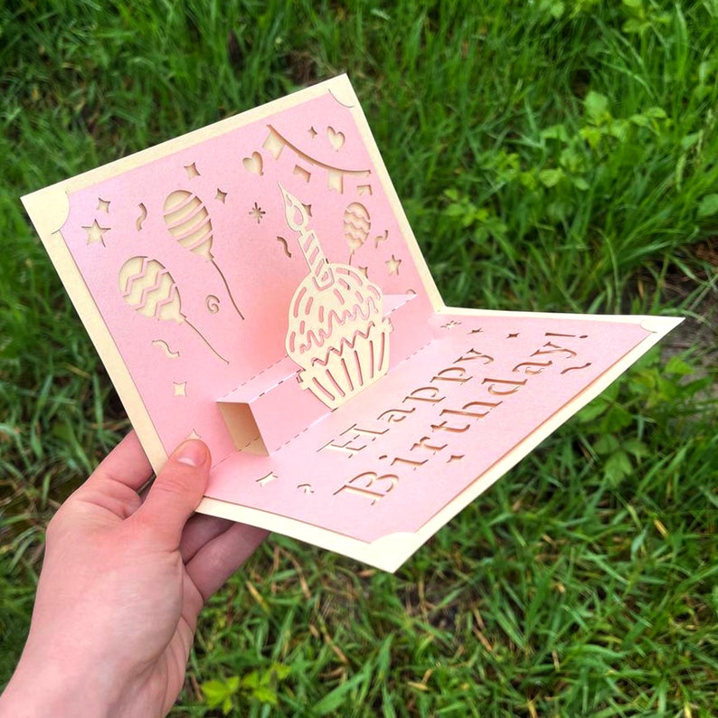 Top angle view of the 3D cupcake birthday card. Shows the dimensional papercut layers and volume, ideal for Glowforge and Cricut machine users.