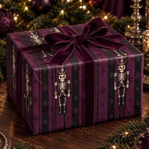 May include: A rectangular gift box wrapped in dark purple and black striped paper featuring a repeating pattern of skeleton nutcracker figures and small snowflakes, topped with a wide, dark purple velvet ribbon tied in a bow.