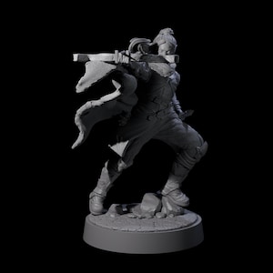 May include: A gray figurine of a warrior in a dynamic pose, holding a crossbow. The figure is clad in detailed armor and a flowing cape, standing on a rocky base. The overall design suggests a fantasy theme.