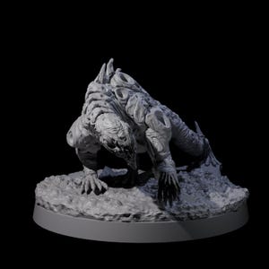 May include: A grey sculpture of a mutated creature with a detailed, textured surface. The figure is depicted on all fours, with a hunched posture and sharp claws. The sculpture is set on a circular base against a black background.