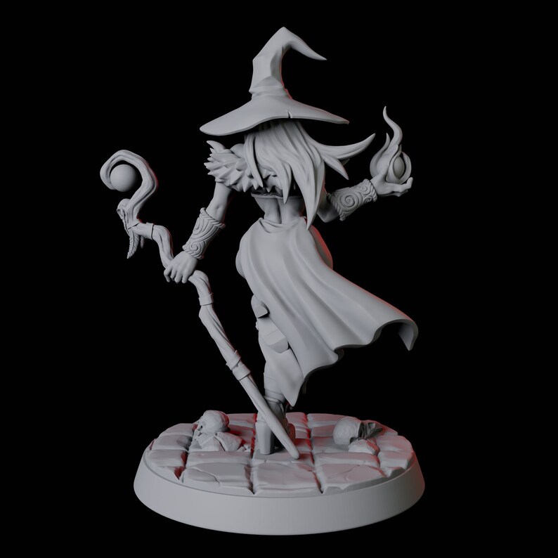 May include: A gray 3D printed miniature of a female witch wearing a pointed hat and holding a staff with a sphere on top. She is wearing a long robe and has long hair. She is standing on a circular base with a stone texture.