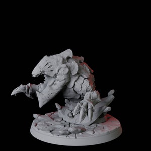 May include: A grey, detailed, 3D printed miniature of a creature with a large mouth and sharp claws. The creature is posed on a rocky base.