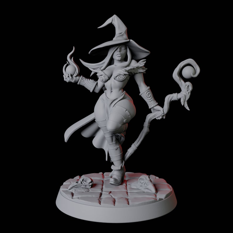 May include: A gray painted miniature figurine of a female witch wearing a pointed hat and holding a staff with a glowing orb at the top. She is wearing a short dress and boots. The figurine is standing on a circular base with a stone-like texture.