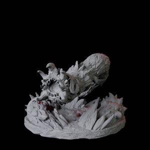 Puede incluir: Escultura gris de criatura fantástica con boca grande y dientes afilados. La criatura está rodeada de formaciones rocosas irregulares, evocando un monstruo o bestia mítica.