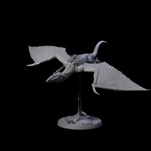 May include: A grey dragon sculpture with large wings, supported by a stand. A smaller lizard figure sits on the dragon's back. The model has intricate detailing and is displayed against a black backdrop.