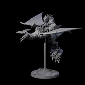 May include: A detailed grey figurine of a dragon with a rider. The dragon has large wings and an open mouth, and the rider is armoured. The figurine is mounted on a stand with a circular base.
