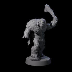 May include: A gray, detailed figurine of a reptilian humanoid creature, holding a large, serrated blade above its head. The figure has a muscular build, with textured skin and wrapped bandages on its legs. It stands on a circular base against a black background.