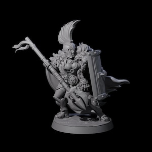 May include: A gray miniature figurine of a warrior in a helmet with a feathered crest, holding a spear and shield. The warrior is wearing armor and a fur-like garment. The shield has a decorative design.