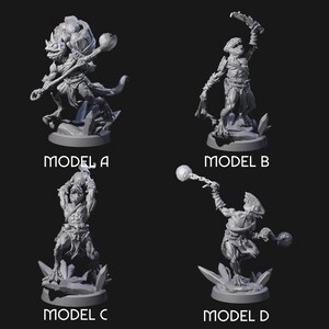 May include: Four gray 3D-printed fantasy creature models, each on a base. Model A is a beast-like figure with a club. Model B is a humanoid with a raised arm. Model C is a muscular humanoid. Model D is a creature with a ball-tipped weapon. Each model is labeled.