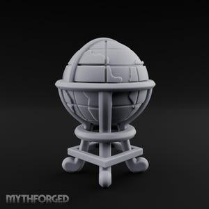 May include: A matte gray miniature globe sculpture featuring raised continental outlines and a grid of latitude and longitude lines. The globe is supported by a circular frame resting on a square base with four curved feet. The text MYTHFORGED is visible.