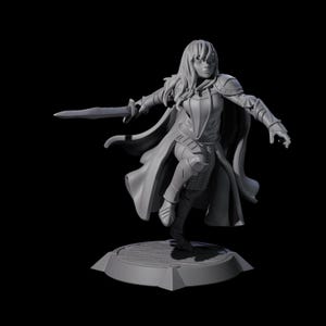 May include: A grey 3D-printed figurine of a female warrior in a dynamic pose, holding a sword. She wears armour, a flowing cape, and stands on a circular base. The figure is set against a black background.