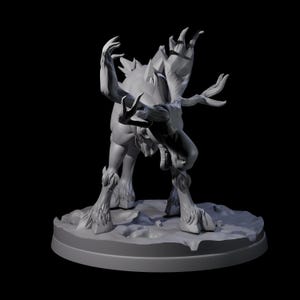 May include: A grey 3D-printed figurine of a mythical creature with antlers, claws, and a snarling expression. The figure is posed dynamically, with arms raised and mouth open, on a circular base.