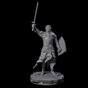 May include: A gray figurine of a knight in full armor, holding a sword aloft with one hand and a shield in the other. The knight stands on a stone base, with intricate details in the armor and facial features.