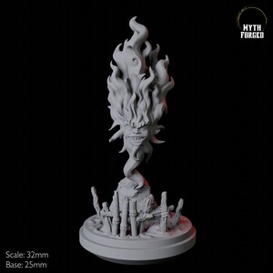 May include: A gray 3D-printed sculpture of a fiery, grinning face with flames for hair. The sculpture is mounted on a base with a rocky terrain and wooden fence details. The text "Myth Forged" is in the upper right corner.