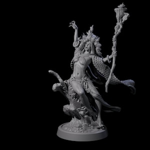 May include: A gray figurine of a woman with her arms raised, wearing a cloak and holding a staff. The figurine is set on a base and has a detailed design, with a dark background.