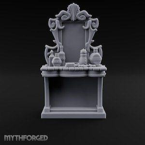 May include: A grey miniature vanity table featuring an ornate, scrolled mirror frame and a flat surface holding several small bottles, a brush, and spherical objects. The base is rectangular with a hollow centre, and the text MYTHFORGED is visible.