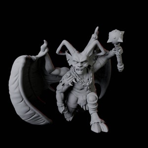 May include: A grey 3D model of a demonic figure, featuring horns, wings, and a mace. The creature is posed dynamically, with a bent knee and outstretched wings. It has a skeletal face and is decorated with chains and armour.