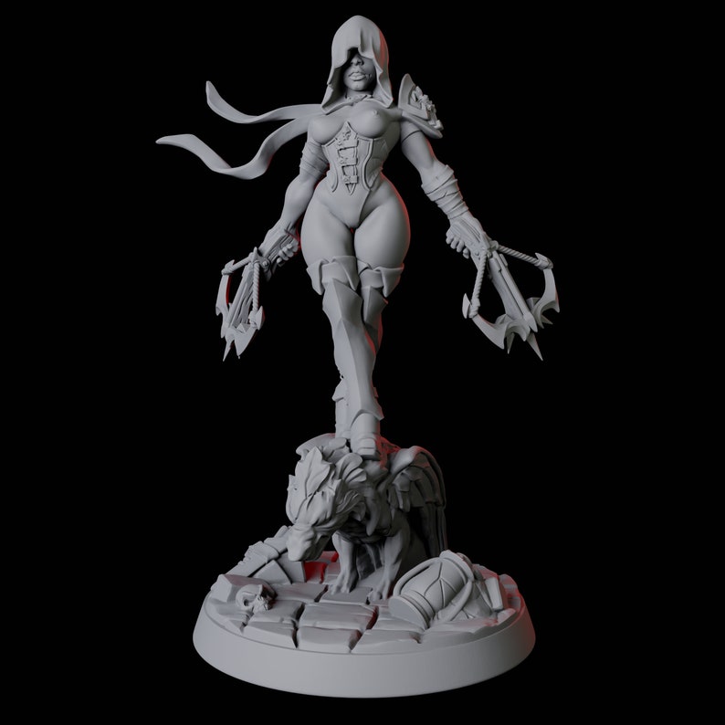 May include: A gray figurine of a hooded warrior woman, holding two crossbows. She stands atop a stone base with a wolf-like creature. The figure is detailed with armor and a corset, with flowing fabric from the hood.