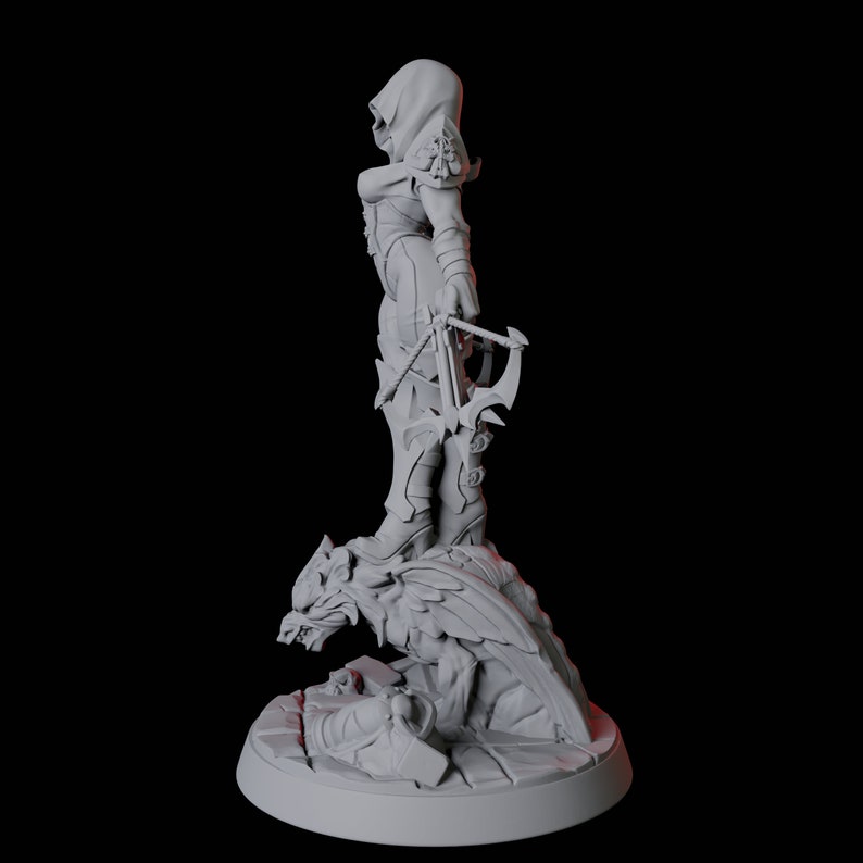 May include: A gray figurine of a hooded figure holding a crossbow, standing on a detailed base with a wolf-like creature. The figure is wearing armor and boots. The base is round and has intricate details.