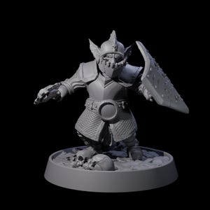 May include: A gray, 3D-printed fantasy miniature of a goblin warrior. The goblin is armored, holding a shield and a skull. The miniature is on a round base with skulls.