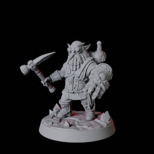 May include: A grey, detailed miniature figurine of a dwarf with a beard, goggles, and a mechanical arm holding a pickaxe. The dwarf is standing on a round base with a textured surface.