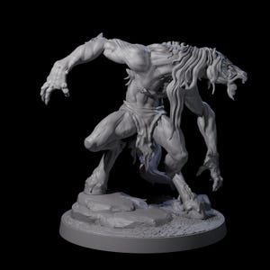 May include: A gray, three-dimensional sculpture of a monstrous humanoid creature. The creature has long hair, sharp teeth, and claws. It is posed on a rocky base, with a loincloth. The sculpture is set against a black background.
