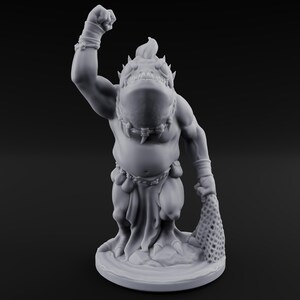 Peut inclure: Figurine grise d'une créature humanoïde musclée avec une grosse tête et des pointes. Il lève un poing en l'air et tient un filet dans l'autre main. La figurine est sur une base ronde.