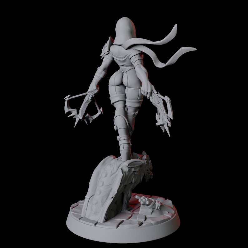 May include: A gray figurine of a character in a hooded cloak, holding two crossbows. The figure is standing on a stone base with a detailed design. The character is wearing tight-fitting clothing and boots.