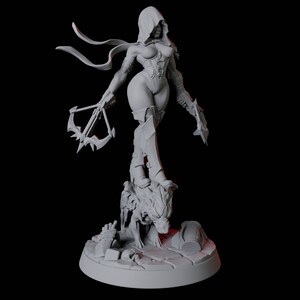 May include: A gray figurine of a female warrior in a hooded cloak, holding crossbows. She stands atop a detailed base with a skull and debris. The figure is in a dynamic pose, with a detailed corset and armor.