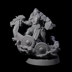 May include: A gray figurine of a Viking warrior standing in a longboat, holding two hammers. The boat has a dragon head at the front and is set on a base with a wave design. The warrior has a long beard and is wearing armor.