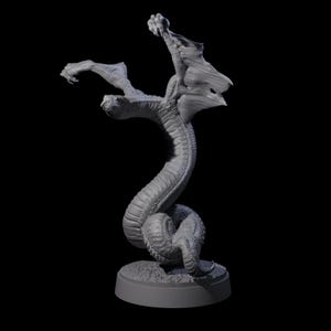 May include: A grey, three-headed dragon sculpture with outstretched wings and a coiled body. The detailed fantasy figure is posed on a circular base, with a textured surface and a dark background.