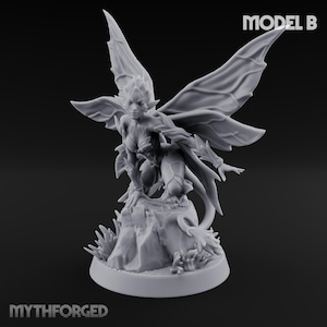 May include: A grey figurine of a fairy, kneeling on a rock formation. The fairy has large, detailed wings and is adorned with leaf-like details. The base of the figurine is round, and the text "MODEL B" is visible.