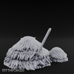 May include: A grey miniature hay bale set with a pitchfork. The larger bale has a layered, textured design, and the smaller bale is beside it. The pitchfork is inserted into the larger bale. The text "MYTHFORGED" is at the bottom.