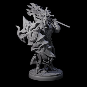 May include: A gray, detailed figurine of a warrior in ornate armor, holding a large shield and a weapon. The figure stands on a circular base, with intricate designs on the armor and weapon.