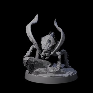 May include: A grey, 3D-printed fantasy creature figurine. The monster has a textured, reptilian appearance with large, curved appendages and is posed on a rocky base. The figurine is set against a black background.