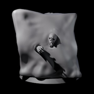 May include: A gray sculpture featuring a skull and a hand emerging from a draped, amorphous form. The skull has an open mouth, and the hand is clenched. The artwork is set against a black background, creating a dramatic contrast.