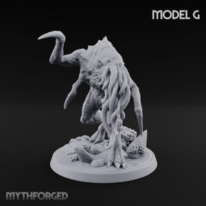 May include: A light grey unpainted resin miniature figure of a creature with a tentacled face, clawed limbs, and a hunched posture, standing on a circular base with rocky textures. The text MODEL G and MYTHFORGED are visible in the image.