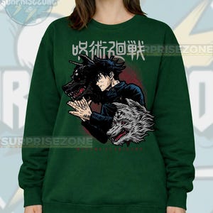 May include: Dark green sweatshirt featuring a graphic of an anime character with two wolf-like creatures. Japanese text is above the character. The sweatshirt has a crew neck and long sleeves. The brand name "SURPRISEZONE" is printed on the top.