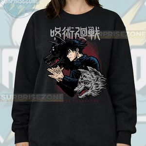 May include: Black sweatshirt featuring a graphic of an anime character with two wolf-like creatures. The design includes Japanese text and the name "Megumi Fushiguro". The sweatshirt has a crew neck and long sleeves.