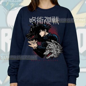 May include: Navy blue sweatshirt featuring a graphic of an anime character with two wolf-like creatures. The design includes Japanese text and the name "MEGUMI FUSHIGURO" in red. The sweatshirt has long sleeves and a crew neck.