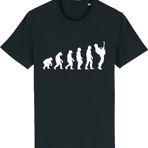 May include: A black t-shirt featuring a white graphic of the evolution of man, culminating in a person playing a guitar.
