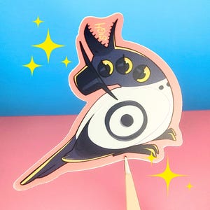 May include: A die-cut sticker featuring a stylized bird with a white body, dark blue head and tail, and yellow accents. The sticker has a pink border and the word "SIGH" is printed on the top. Yellow starbursts are in the background.