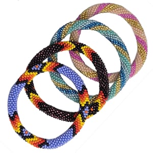 May include: Four beaded bracelets in various colors. One bracelet is black with orange, yellow, and red accents. Another is blue with yellow and orange accents. The third is blue, gold, and teal. The last is pink, gold, and tan.
