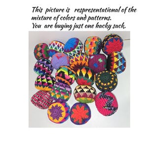 May include: A collection of round, crocheted hacky sacks featuring various geometric patterns and vibrant colors including red, blue, yellow, green, and purple. Text reads: This picture is respresentational of the mixture of colors and patterns. You are buying just one hacky sack.