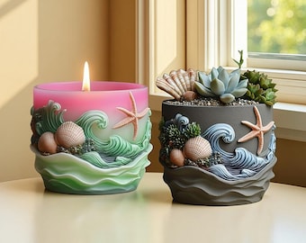 May include: A lit pink candle and a grey planter with a succulent. The candle has a wave and seashell design with a starfish. The planter has a wave and seashell design with a starfish and a succulent.